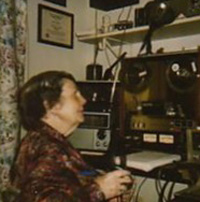 Sarah Estep sitting in front of real to real tape recorder